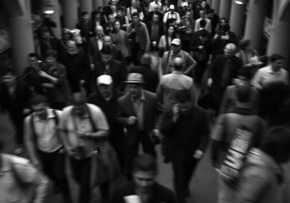 Crowd in motion, black and white documentary photograph